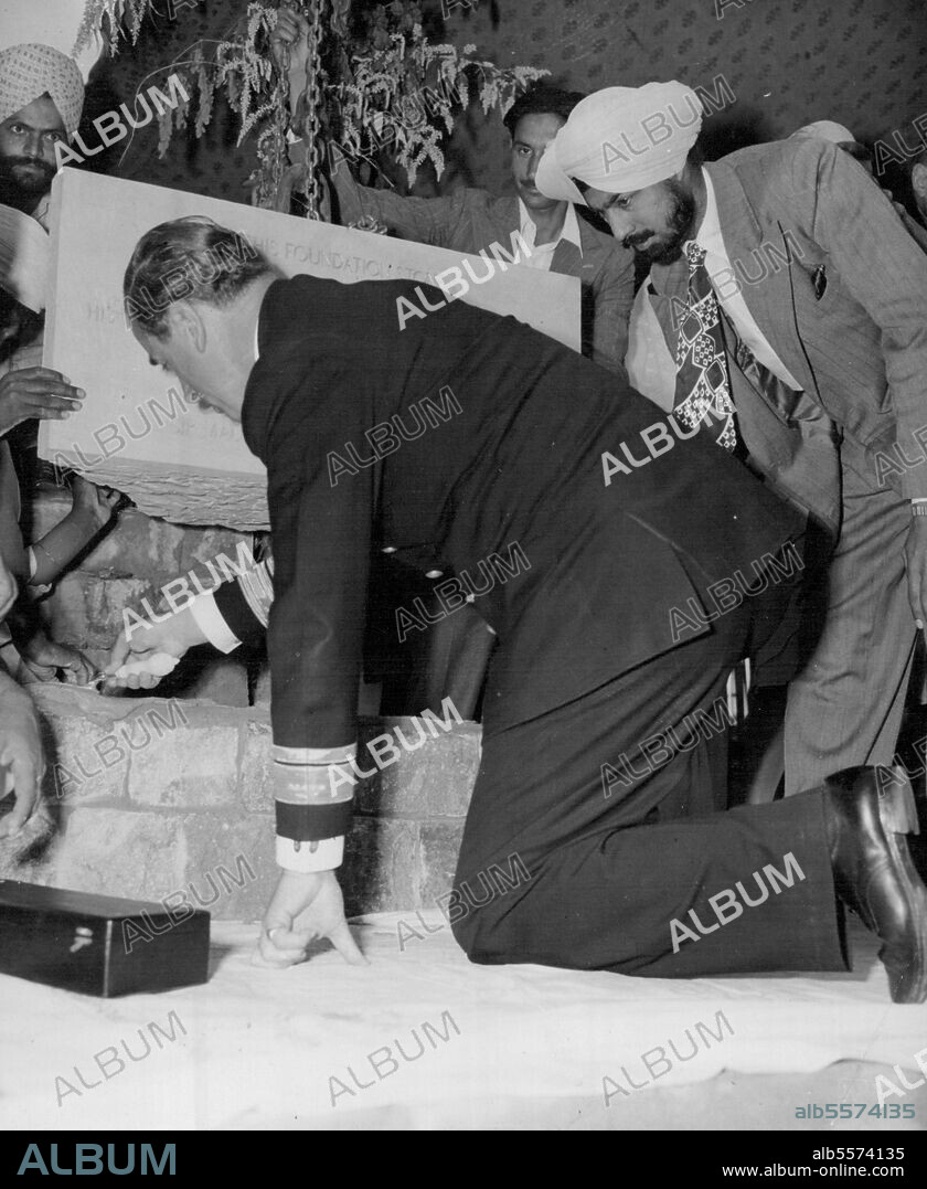 Mountbatten Lays Foundation Stone - Early Mountbatten, Governor General of India, crouches on both knees to level the cement with a silver trowel for a foundation stone at Delhi University, India, March 7. The Governor, Earlier conferred the honorary degree of Doctor of letters on Pandit Nehru, Prime Minister of India, and was later himself invested with the degree of Doctor Science. March 13, 1948. (Photo by Associated Press Photo).