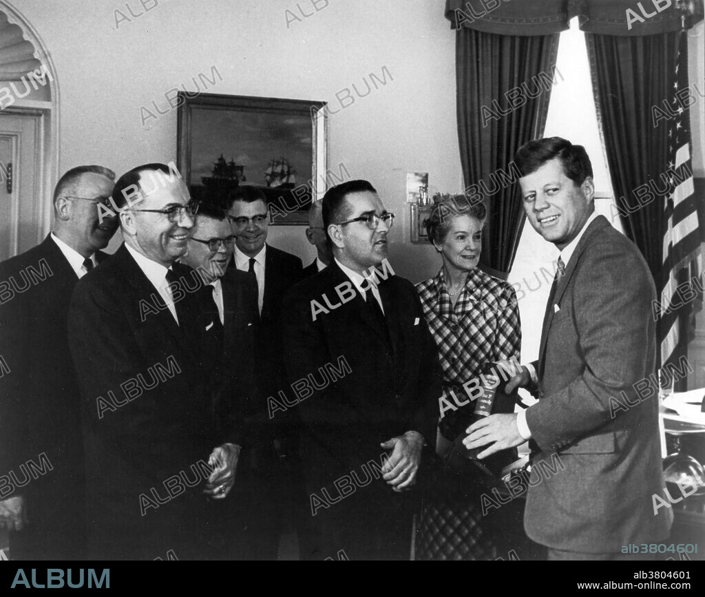 Presentation of the first volumes of the "Public Papers of the Presidents of the U.S., John F. Kennedy." At the White House, April 17, 1962. Shown are D.C. Eberhart, James L. Harrison, Dr. Grover (Archivist of U.S.), Frank H. Mortimer, Warren R. Reid, Bernard Boutin (Administrator, GSA), Mildred Barry, John F. Kennedy. John Fitzgerald Kennedy (May 29, 1917 - November 22, 1963) was the 35th President of the United States, serving from 1961 until his death in 1963. He was the youngest elected to the office, at the age of 43, and the first person born in the 20th century to serve as president. He was the only Catholic president, and is the only president to have won a Pulitzer Prize. Events during his presidency included the Bay of Pigs Invasion, the Cuban Missile Crisis, the building of the Berlin Wall, the Space Race, the African-American Civil Rights Movement, creation of the Peace Corps, and early stages of the Vietnam War. Kennedy was assassinated on November 22, 1963 in Dallas, Texas by Lee Harvey Oswald. He continues to rank highly in public opinion ratings of US presidents.