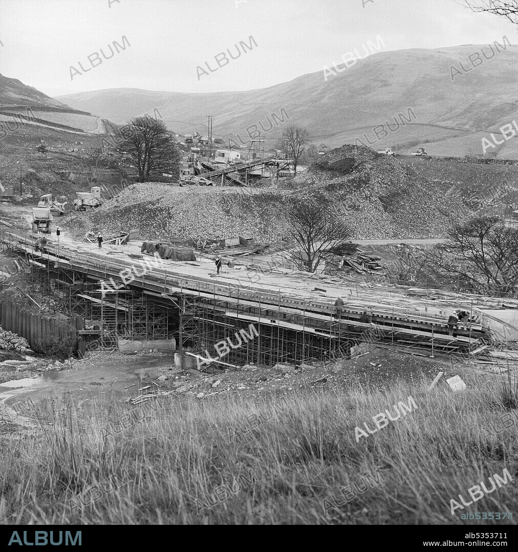 JOHN LAING PLC. A view of the construction of the M6 Motorway through the Lune Gorge, showing the building of a bridge across a stream or river. The work on the Lune Gorge section of the M6 Motorway between Killington and Tebay (Junction 37 - Junction 38) was carried out by John Laing Construction Ltd. Work started in October 1967 and the motorway was opened to traffic in October 1970. On this stretch of the M6, 20 bridges and 17 culverts were built across rivers and streams.