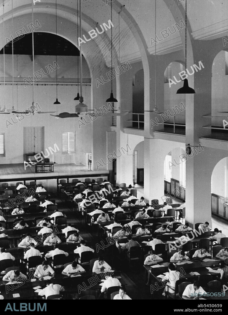 The New City at Dragon-Teeth GateRaffles College and the Raffles Institution stand as memorials to the foresight of the founder of Singapore, who said "Education must keep pace with commerce in order that its benefits may be ensured and its evils avoided." These students are taking the annual examination in the main hall of Raffles College. (Photo By Central Office of Information Photo).