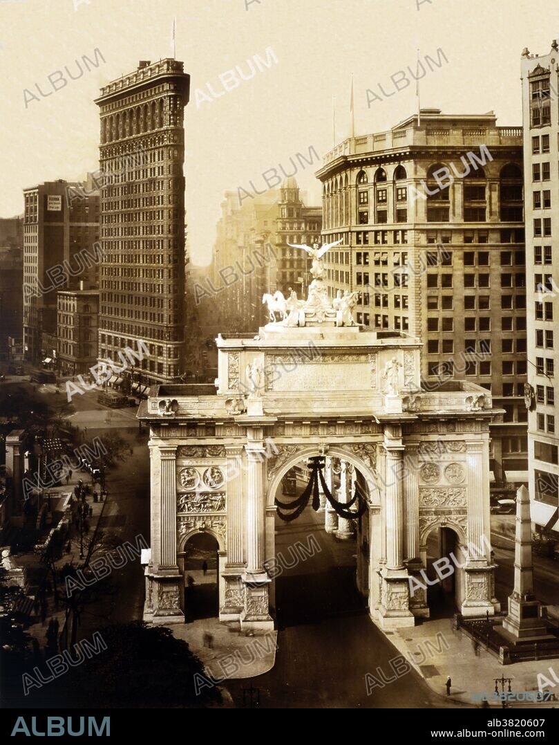Bird's-eye view of Victory Arch and Flatiron Building. In 1918 Mayor John F. Hylan had a Victory Arch built over Fifth Avenue and 24th Street at Madison Square to commemorate New Yorkers who had died in WWI. The arch was designed by Thomas Hastings and was modeled after the Arch of Constantine in Rome using temporary materials (wood and plaster). Relief panels commemorating important battles and war service organizations covered the $80,000 triple arch. Plans to make the Victory Arch a permanent monument were thwarted by a group of sculptors who felt it was too vengeful towards the Germans, and Fiorello H. LaGuardia publicly denounced the project as an "Altar of Extravagance." Photographed by Irving Underhill, 1919.