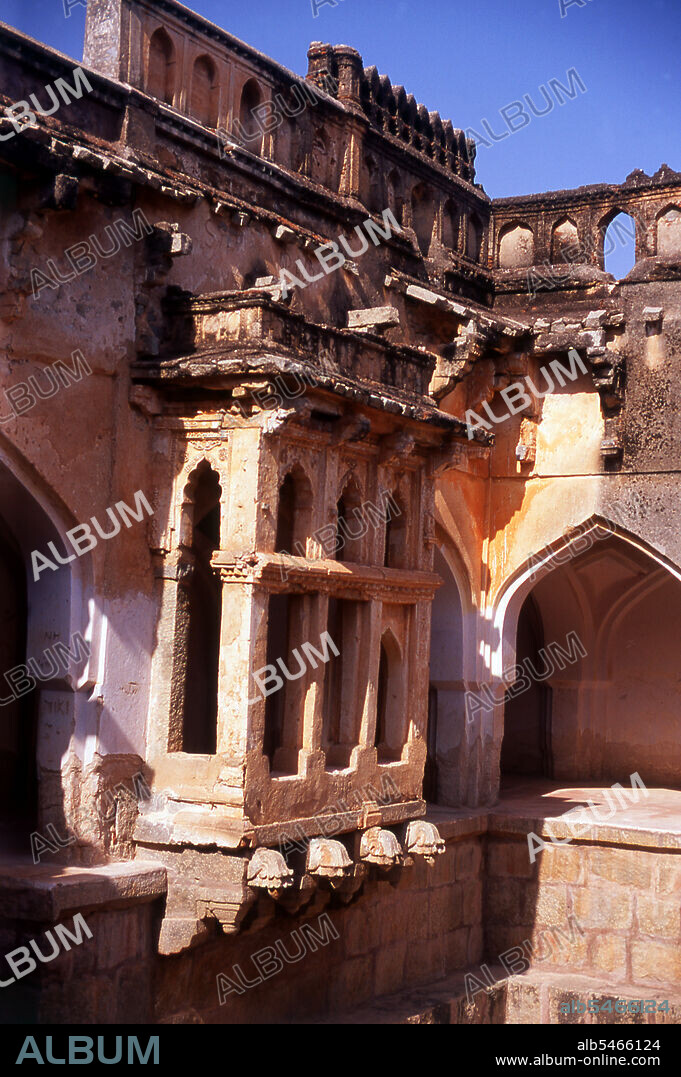 The Queen's Bath is part of the Royal Enclosure and the tank (pool) in the middle is believed to have been filled with perfumes and flowers. Hampi is a village in northern Karnataka state. It is located within the ruins of Vijayanagara, the former capital of the Vijayanagara Empire. Predating the city of Vijayanagara, it continues to be an important religious centre, housing the Virupaksha Temple, as well as several other monuments belonging to the old city.