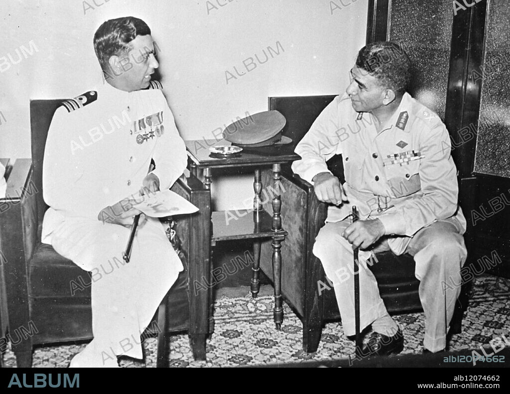 INDIAN NAVY'S GOODWILL VISIT TO EGYPT 14.8.53. Three Indian destroyers, the I.N.S. Godavari, I.N.S. Gomati and I.N.S. Ganga, paid a four-day goodwill visit to Egypt last week. The ships, which docked at Alexandria, were under the command of Commander Kohli. I.N.P. photo shows Commander Kohli (left) chatting to President Neguib at the Ports and Lighthouse Administration, Alexandria. The Commander is holding the swagger stick and autographed photo which he received as gifts from the President. International News Photos.