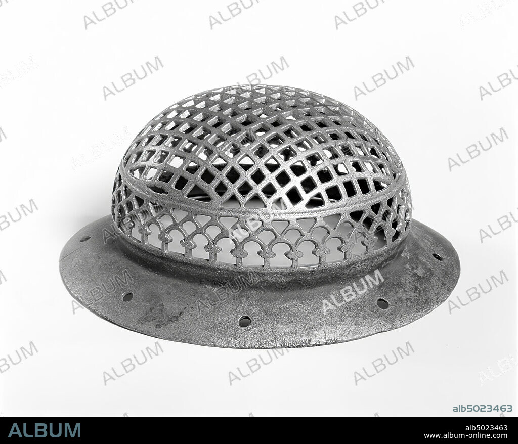 Bronze eye protector of a horse. On a conical bottle rim with 8 perforations, a hemisphere completely cut out into grilles. From below, successively: arcs on small columns, at the top of which to both sides a bulge, triangles. Then a relatively wide, circular ring with a central quarry. Above it, filling the entire convex part, a grille, created by looking at windows. Our ex. was possible part of a leather horse harness., cap, horse eye protection, metal, bronze, height: 6,5 cm, roman 1-300 AD, Netherlands, North Brabant, Oss, Lith, Maas.