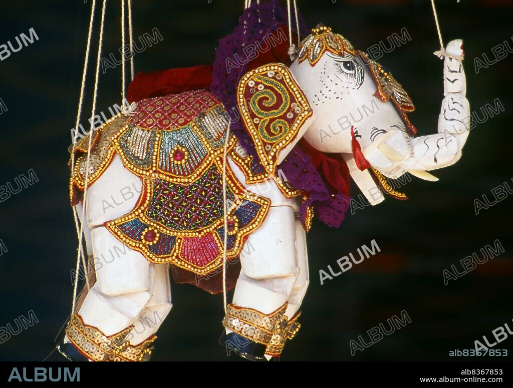 Burma / Myanmar: A traditional Burmese elephant puppet (Yoke thé) on sale, Bogyoke Aung San Market, Yangon (Rangoon). Yoke thé (lit. miniatures) is the Burmese name for marionette puppetry. Although the term can be used for marionettery in general, its usage usually refers to the local form of string puppetry. Like most of Burmese refined art, Yoke thé performances originated from Royal patronage and were gradually adapted for the wider populace. Yoke thé are almost always performed in operas.
