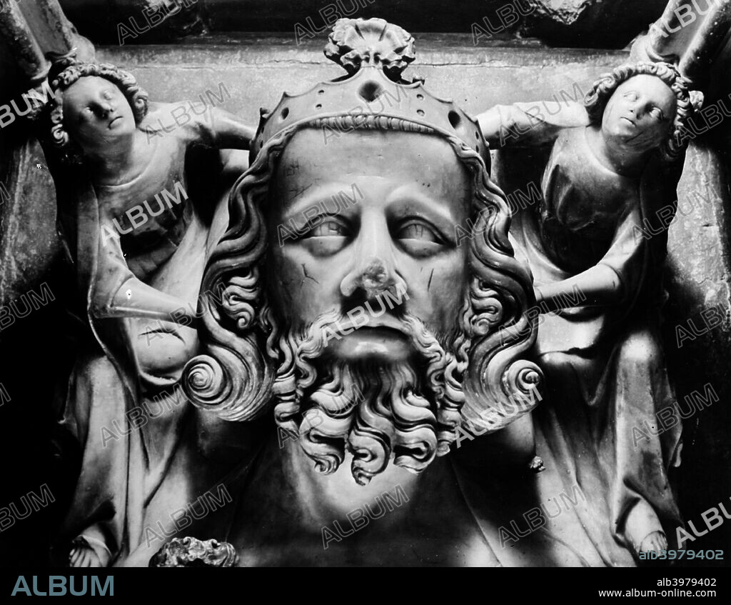Tomb of Edward II, Gloucester Cathedral, Gloucestershire, 1945. The head of King Edward II supported by two female figures, carved in alabaster, from his tomb in the north ambulatory of Gloucester Cathedral. Edward died on 21st September 1327, and his monument was erected soon afterwards.