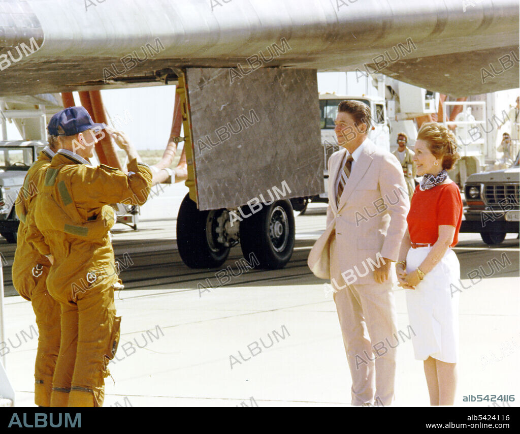 Mattingly and Hartsfield Salute President Reagan, Edwards Air Force Base, California, USA, 1982. Columbia Space Shuttle astronauts Commander Thomas K. Mattingly, foreground, and Pilot Henry W. Hartsfield salute President Ronald Reagan and his wife, Nancy, as the astronauts begin the customary walk-around inspection of the orbiter after landing. Mattingly and Hartsfield were the first to land the Shuttle on a concrete runway. The landing proved that the shuttle could return safely to a precisely targeted location on Earth.