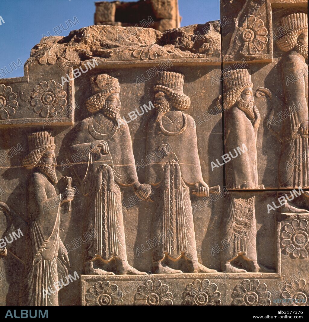A detail of a relief carving on the staircase leading to the Tripylon at Persepolis, depicting the procession of Medes and Persians. The Persians are wearing fluted hats. Culture: Achaemenian, Time of Xerxes I. Date/Period: c. first half of 5th c BC. Place of Origin: Persepolis, Persia. Credit Line: Werner Forman Archive . Location: 18.