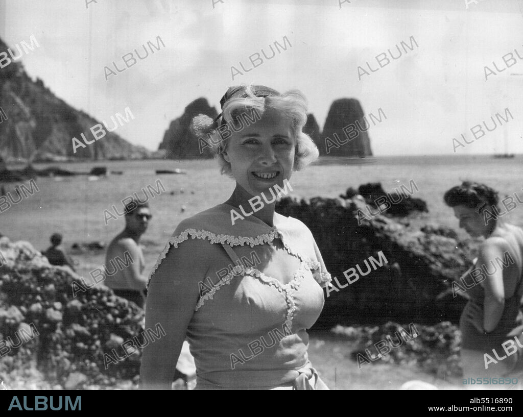 Mrs. Luce At Capri -- Mrs. Clare Boothe Luce, United States Ambassador to Rome, is seen on the Isle of Capri, August 24th, where she is spending a few days rest.In Background are seen Capri's famed "Faraglioni" rocks.Ambassador for US to Rome, Mrs. Clare Boothe Luce enjoys the sunshine on the Isle of Capri where she recently spent a few days' rest. September 1, 1953. (Photo by Associated Press Photo).