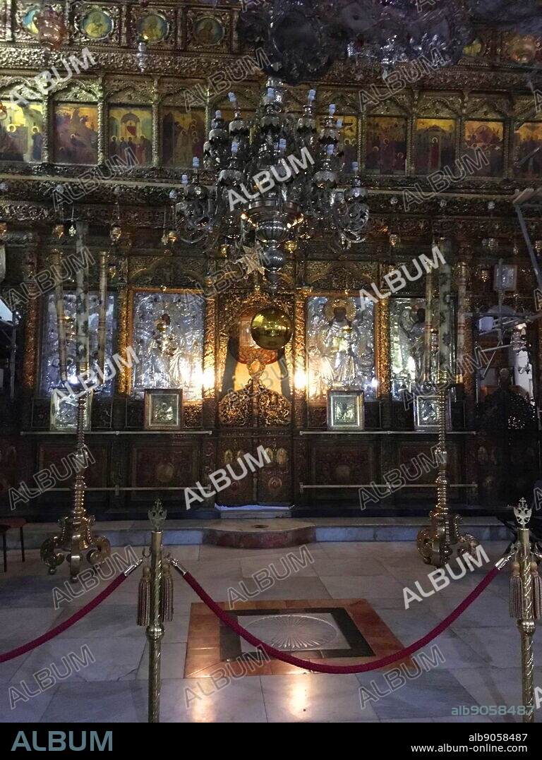 Restored altar in the Church of the Nativity; Bethlehem, in the West Bank, Palestine. The church was originally commissioned in 327 by Constantine the Great and his mother Helena over the site that was traditionally considered the birthplace of Jesus. The Church of the Nativity site's original basilica was completed in 339 and destroyed by fire during the Samaritan Revolts in the 6th century. A new basilica was built 565 by Justinian, the Byzantine Emperor, restoring the architectural tone of the original.