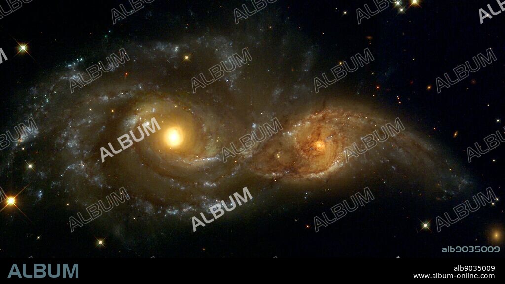 Interacting Spiral Galaxies NGC 2207 and IC 2163. In the direction of the constellation Canis Major, two spiral galaxies pass by each other like majestic ships in the night. The near-collision has been caught in images taken by NASA's Hubble Space Telescope and its Wide Field Planetary Camera 2. The larger and more massive galaxy is cataloged as NGC 2207 (on the left in the Hubble Heritage image), and the smaller one on the right is IC 2163. Strong tidal forces from NGC 2207 have distorted the shape of IC 2163, flinging out stars and gas into long streamers stretching out a hundred thousand light-years.