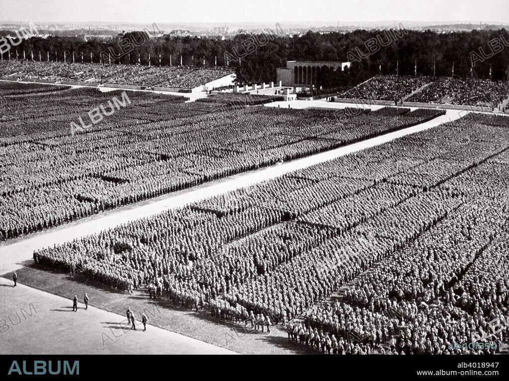 Stormtroopers lined up on parade during a Nazi Party Congress in Nuremberg, Germany, 1936. From Germany: The Olympic Year, published by Volk und Reich Verlag. (Berlin, 1936).