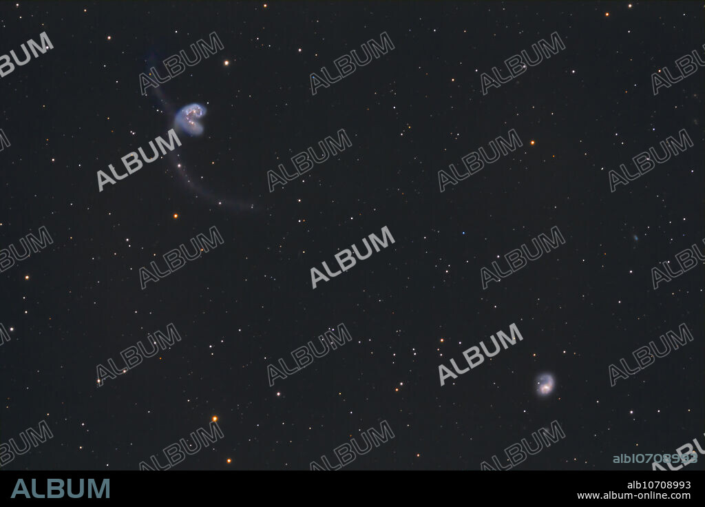 The Antennae Galaxies, NGC 4038 and 4039 (top left) are a pair of interacting galaxies in the constellation of Corvus. Galaxy NGC 4027 is also visible at bottom right.