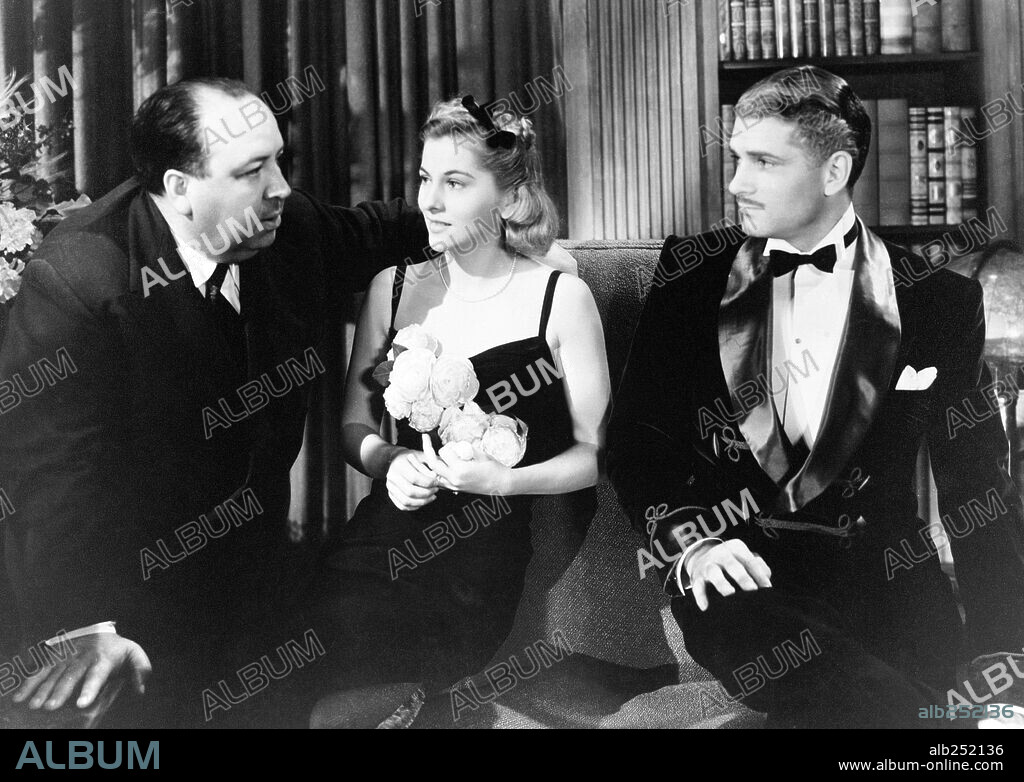 JOAN FONTAINE, ALFRED HITCHCOCK and Laurence Kerr Olivier. ALFRED HITCHCOCK, JOAN FONTAINE and LAURENCE OLIVIER in REBECCA, 1940, directed by ALFRED HITCHCOCK. Copyright Selznick International Pictures.