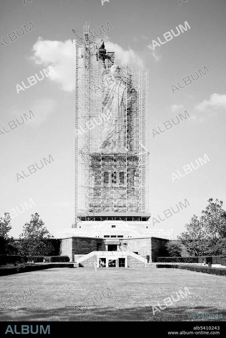 Rear view looking south showing statue, pedestal and Fort Wood. A centennial conservation-restoration of the Statue of Liberty occurred between 1984-86. The Statue of Liberty, by French sculptor Frédéric Auguste Bartholdi, is a colossal artwork on Liberty Island in New York Harbor, and is a part of the Statue of Liberty National Monument. Much of the restoration effort was based on unprecedented restorative methods, as metallurgical repair work on such a large scale had never been attempted. Many scientists, engineers, government organizations, and professional consultants evaluated and dealt with the various problems and tasks facing the restoration effort. Historic American Engineering Record, Jet Lowe, 1984 (cropped and cleaned).