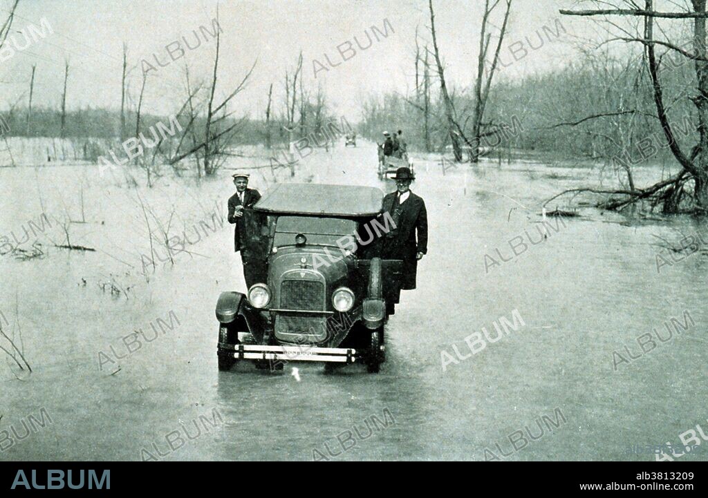 The Great Mississippi Flood of 1927 was the most destructive river flood in the history of the United States. The flood began when heavy rains pounded the central basin of the Mississippi in the summer of 1926. By September, the Mississippi's tributaries in Kansas and Iowa were swollen to capacity. Flooding overtook the levees causing the Mounds Landing to break with more than double the water volume of Niagara Falls. The Mississippi River broke out of its levee system in 145 places and flooded 27,000 square miles. This water flooded an area 50 miles wide and more than 99 miles long. The flood caused over $400 million in damages and killed 246 people in seven states. The flood affected Arkansas, Illinois, Kentucky, Louisiana, Mississippi, Missouri, Tennessee, Texas, Oklahoma and Kansas. By May 1927, the Mississippi River below Memphis, Tennessee, reached a width of 60 miles. Photo originally captioned: "The Great Mississippi River Flood of 1927. Highway between Mounds, Illinois, and Cairo Illinois, March 25, 1927 - river stage at Cairo, Illinois, 52.8 feet." From: "The Floods of 1927 in the Mississippi Basin", Frankenfeld, H.C., 1927. Monthly Weather Review Supplement No. 29.