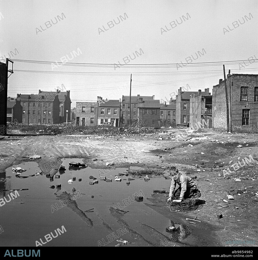 Child playing in slum, St. Louis, Missouri, USA, Arthur Rothstein, U.S. Farm Security Administration, March 1936.