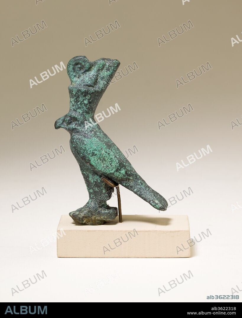 Horus falcon in double crown. Dimensions: H. 5.4 cm (2 1/8 in.); W. 1.6 cm (5/8 in.); L. 3.5 cm (1 3/8 in.)
H. (with tang): 5.9 cm (2 5/16 in.). Date: 664-30 B.C..
The falcon god Horus stands with his wings swept back. He wears the double crown of Egypt, a royal crown that symbolizes the union of Lower and Upper Egypt, and highlights Horus' role as the legitimate ruler of the entire land. The falcon wears the double crown because Horus and the concept of kingship were closely tied, as early as the Predynastic Period. 
The falcon stands on a rectangular platform, which could have functioned in a number of ways. The figure could have been attached to a separate cupreous metal or wooden base, or it could have topped a standard modeled after those used in festival processions and on sacred barks. The falcon also could have sat on top of a hollow box intended for holding an animal mummy, like 41.160.107. Such falcon mummy boxes, or sarcophagi, would have been offered for deposition in animal necropoleis, not just in relation to the cult of Horus, but also more broadly in association with solar cult.