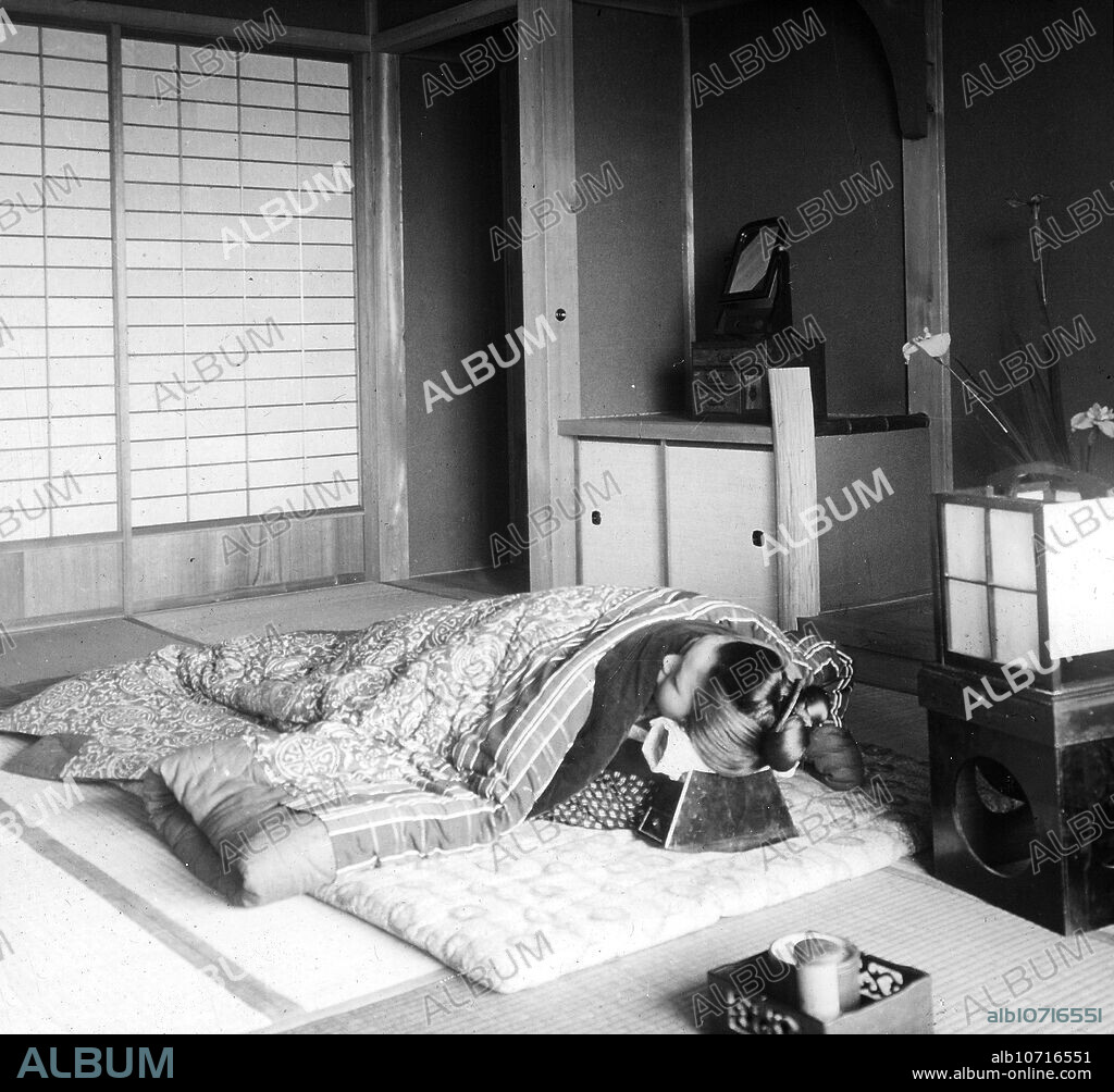 [ 1900s Japan - Japanese Woman Sleeping on Futon ] A woman sleeps on a futon. Her head is resting on a high pillow (hakomakura) to protect her hairstyle. 20th century vintage glass slide.