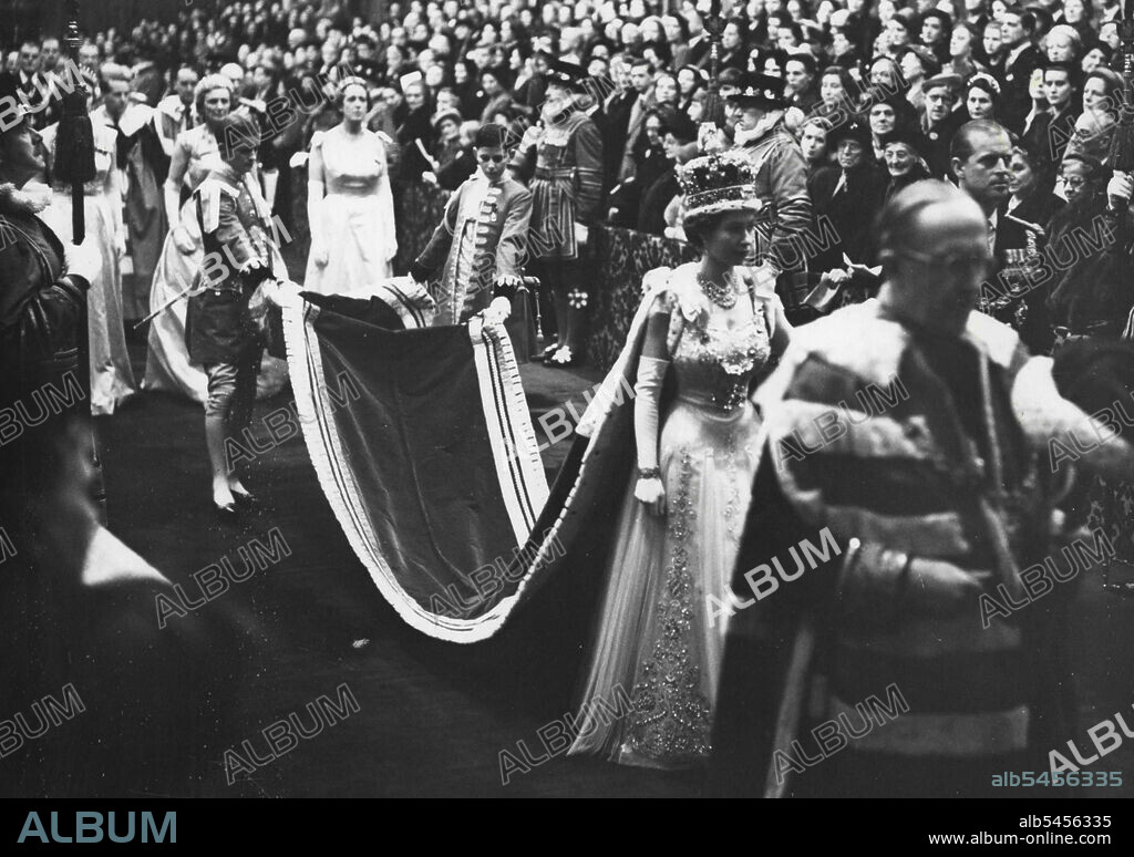 State Opening Of Parliament.The magnificent scene of pageantry as Her Majesty The Queen in her Robes and wearing the Imperial Crown, leaves the Robing Room and walks in procession through the Royal Gallery to the Chamber of the House of Lords to perform the State Opening of Parliament. Her Majesty is accompanied by H.R.H. The Duke of Edinburgh and proceeding them (extreme right) is The Marquess of Salisbury bearing the Cap of Maintenance. Her Majesty's pages are the Hon. Anthony Tryon and Edward Adeane Esq. (This is the first occasion that it has been allowed to talks a photograph of a reigning Monarch wearing the Imperial Crown in the Royal Gallery). November 30, 1954.