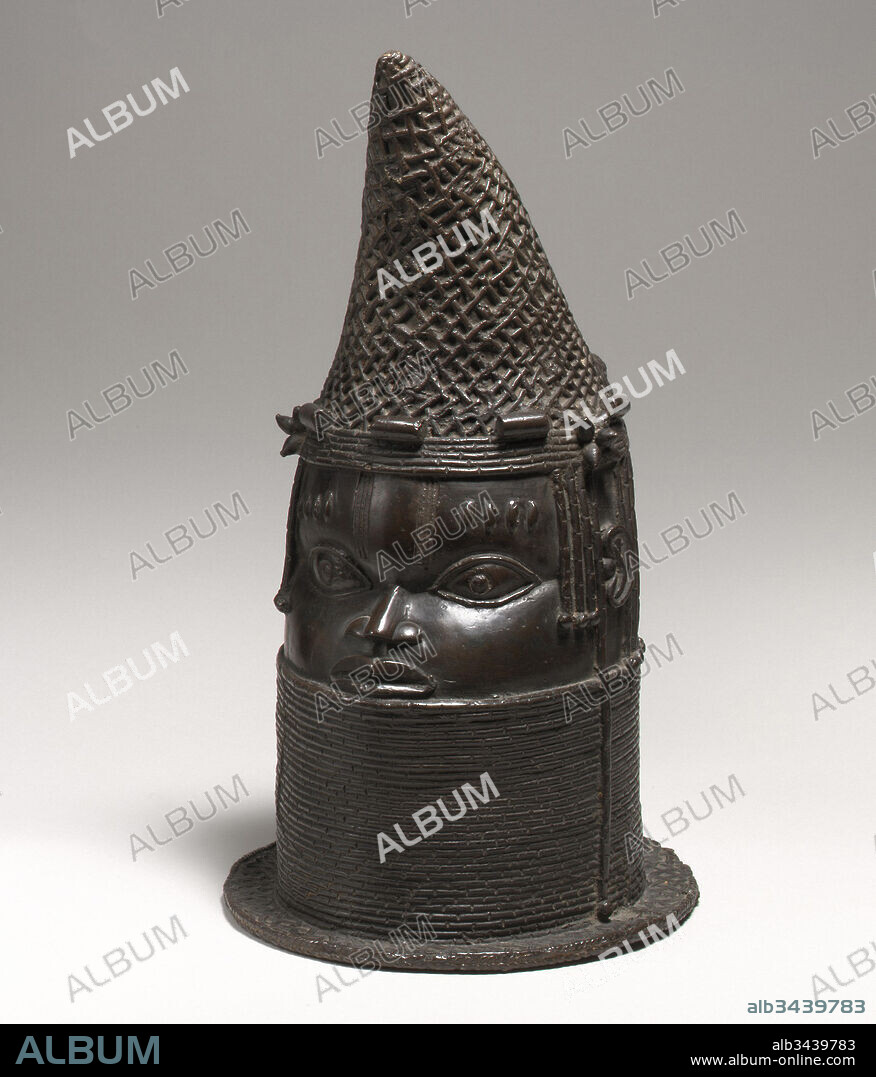 Head of a Queen Mother (Iyoba), 1750–1800, Nigeria, Court of Benin, Edo peoples, Brass, H. 16 3/4 x Diam. 11 3/4 in. (42.5 x 29.9 cm), Metal-Sculpture, In the Benin kingdom, the iyoba, or mother of the oba (king), occupies an important and historically significant place within Benin's political hierarchy. The title was first conferred upon Idia, the mother of king Esigie, who used her political skill and supernatural abilities to save her son's kingdom from dissolution in the late fifteenth century.