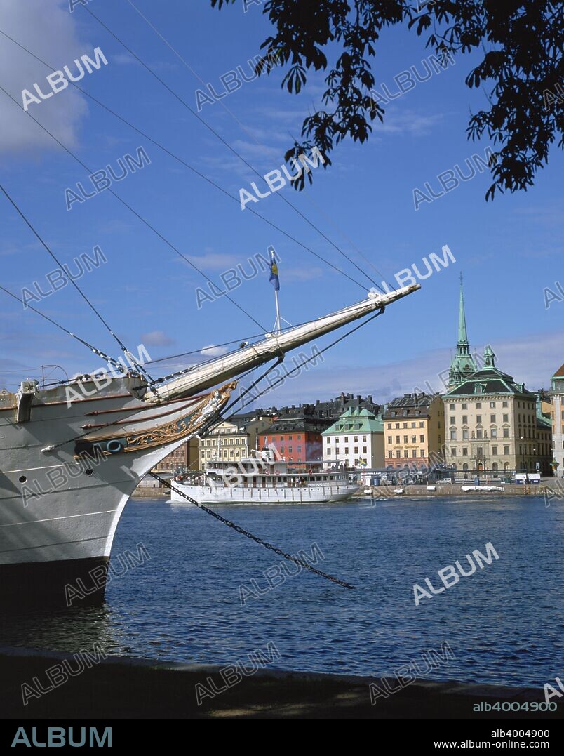 'AF Chapman' sailing ship (youth hostel), Stockholm, Sweden. Gamla Stan, the old town of Stockholm, can be seen in the background. The ship has served as a youth hostel since 1949, run by the Swedish Tourist Association.
