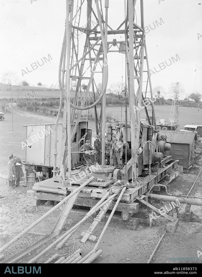 Using a method of drilling never before applied to coal borings and which has enabled them to drill an 8 inch borehole 1,646 feet National Coal Board engineers are working day and night on newly discovered seams of bituminous coal under farmland at Crackley Bank, near Shifnal, Shalop. Picture shows: A general view of the coal drilling at Crackley Bank, showing the 90feet high jack knife boring derrick, and drill. 7th April 1948.