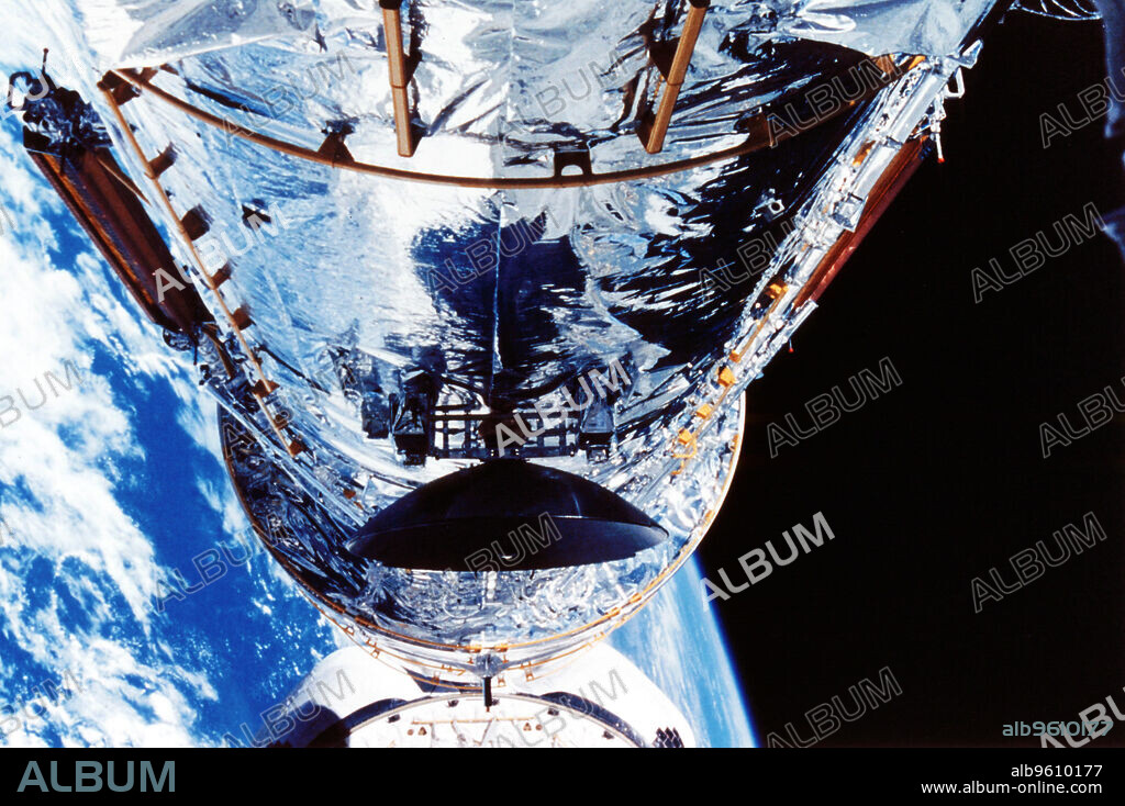 The Hubble Space Telescope orbiting the Earth, c1990s. Launched in 1990, the Hubble Space Telescope (HST) was designed to see seven times further into space than had been possible before, without the distortion caused by the Earth's atmosphere. Problems with its giant mirror meant that it did not initially work as well as expected. Corrective optics were installed in 1993, greatly improving the telescope's performance, enabling it to view the Universe in unprecedented detail. Credit ARPL/NASA.