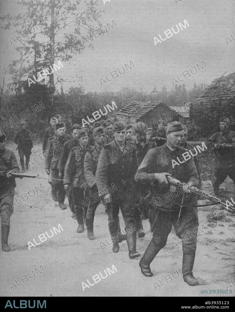 'Nazi Prisoners, captured by Soviet forces, on their way to a field prison camp under an escort of Red soldiers', 1941. From The War Illustrated Volume 5 edited by Sir John Hammerton. [The Amalgamated Press Ltd, London, 1941].