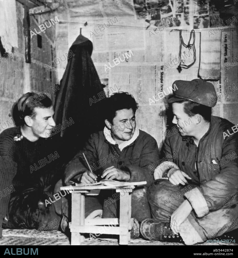 Language Lesson -- This is another of a series, of pictures taken in Communist Prisoner of War Camp 5 at Pyokdong, North Korea, by Frank Noel, AP staff photographer, himself a captive of the Reds for more than a year. Noel's caption said it shows three UN soldiers exchanging language lessons. Left to right: Lance Cpl. William Martin, Colchester, Essex England; Jean Arnaud, Venaes, France, and Pfc, John Ward, Petro, Tenn. Noel's captors permitted him to make the pictures. February 01, 1952. (Photo by AP Wirephoto).