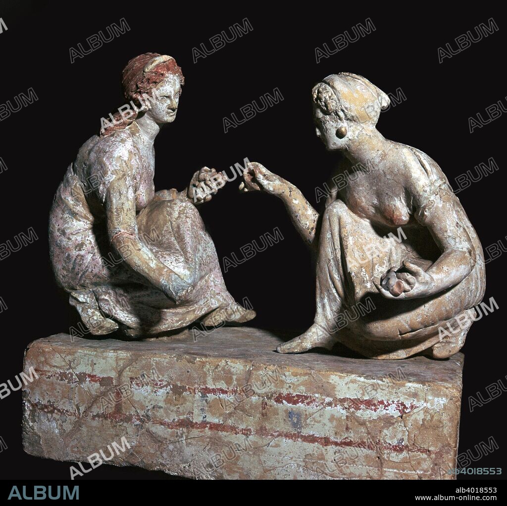 Terracotta group of 'knucklebone' (astragalos) players, Hellenistic Greek,  c330-c300 BC. The two figures play a game similar to the modern game of 'jacks'. It involved throwing the 'knucklebones' up in the air and catching as many as possible on one hand as they fell. The 'knucklebones' were the anklebones of sheep or goats, or models made of ivory, bronze or terracotta. From the British Museum's collection.
