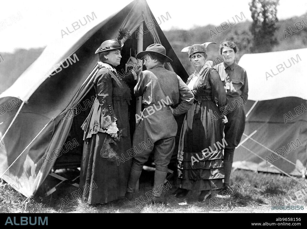 Mary Dimmick Harrison, wife of President Benjamin Harrison and her daughter Elizabeth Harrison Walker with Mrs. Green and probably her daughter, Helen standing at tent of Emergency Services Corps camp where young women were trained in shooting, military drills, hiking and other activities by Army officers, on the estate of Mr. and Mrs. Edward Hewitt, Passaic County, New Jersey, USA, Bain News Service, 1916.