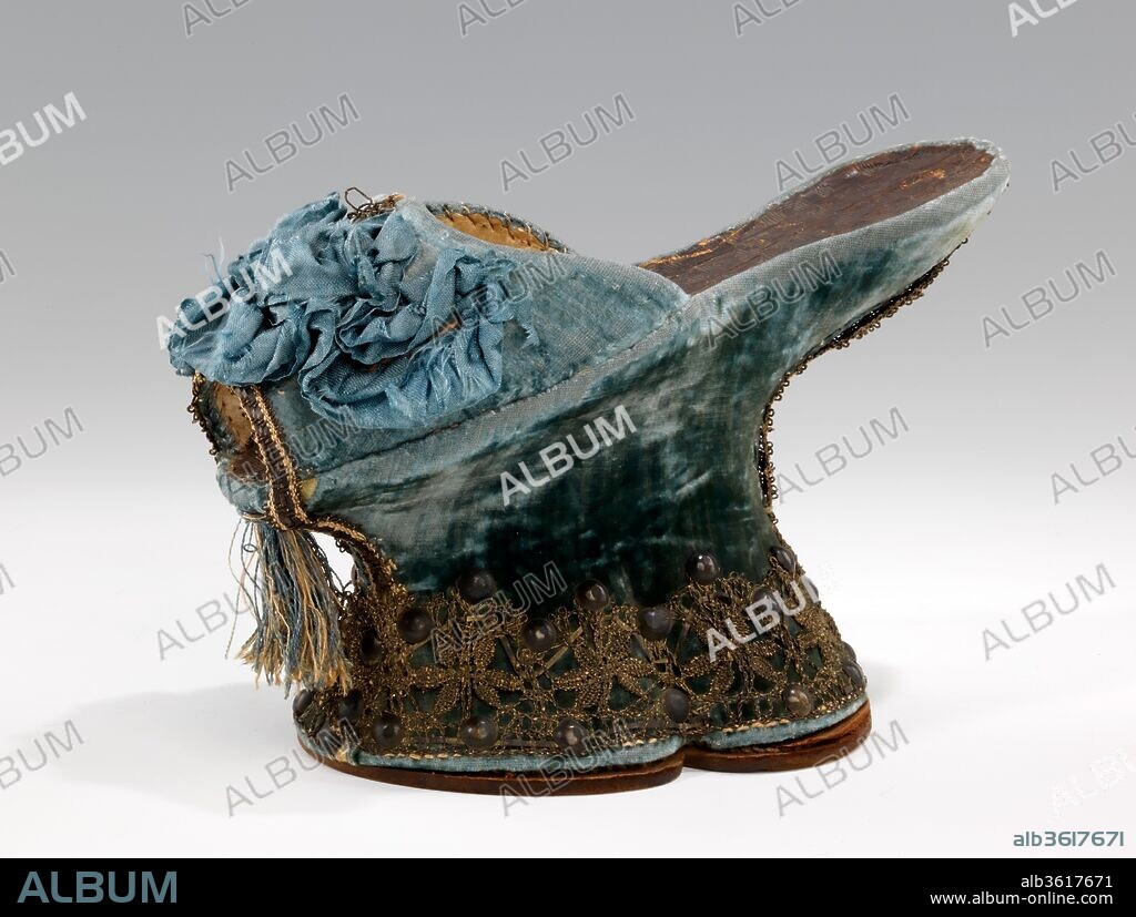 Chopines. Culture: Italian. Date: 1590-1610.
The chopine was a tall clog worn in primarily in Venice from the 15th to the early 17th centuries.  While most examples are between three and five inches tall, some specimens of over a foot tall survive.  Historical accounts testify to the necessity of the assistance of a pair of ladies maids to walk in the more extreme examples.  As can be appreciated from the elaborate and fragile materials, the purpose of the chopine was as much to elevate the lady's sartorial reputation as to elevate her skirt from the dirt of the streets and to increase her physical prominence. While this single chopine is very typical of the form in design and decoration, the blue color is less commonly seen than red or green.  An additional feature of note also found on many other surviving examples is the leather sock lining with incised pattern of concentric squares.