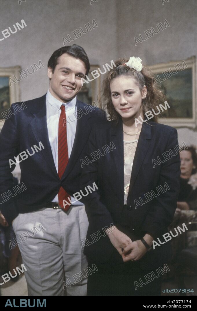 Claudio Amendola and Elena Sofia Ricci on the set of Quei trentasei gradini. Italian actor Claudio Amendola and Italian actress Elena Sofia Ricci posing smiling on the set of Quei trentasei gradini. Italy, 1984.