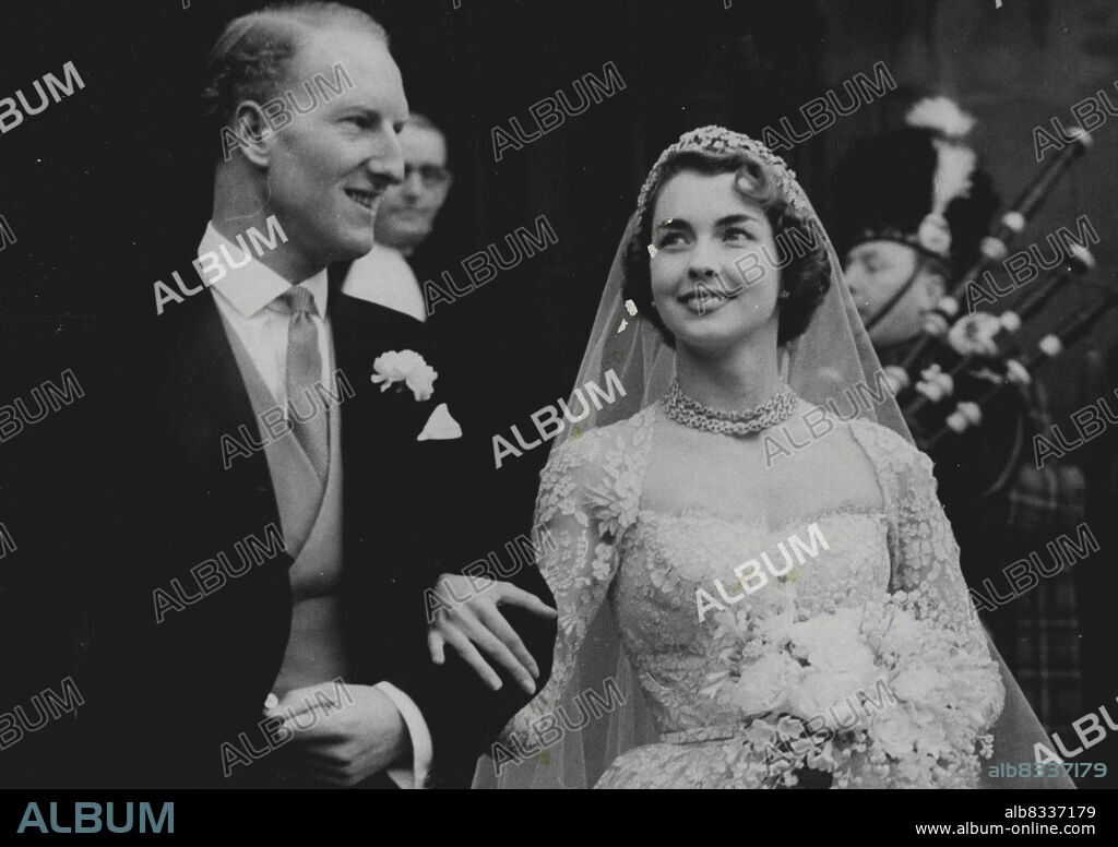 The Queen, the Duke of Edinburgh, Princess Margaret and the Duke and Duchess of Gloucester were guests to., day at the wedding of the year between the 29 - year- old Earl of Dalkeith and Miss Jane McNeill) aged 22. Among the guests were farmers and Gamekeepers. maids, merchants and ministers from five Buccleuch estate. Seven hundred cars and thirty buses carried the I, 600 guests to St.Giles's Cathedral; Edinburgh, for the 40 minute service. Five hundred police were drafted to the cathedral area to control the mammoth crowd of tens of thousands of spectators. In the assembly room after the wedding, all the guests received a glass of champagne and a slice of the 196-lb wedding cake which had the two initials "j s" side by side on the second of its three. January 11, 1953. (Photo by Paul Popper).