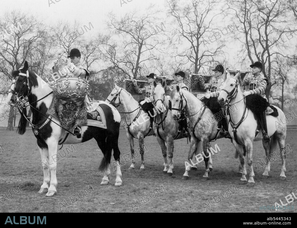 Coronation Fanfare. State trumpeters of the Household Cavalry who will sound a fanfare at the Coronation of Queen Elizabeth, pictured in the full ceremonial dress they will wear, at knights bridge Barracks today. Leading is Corporal E. Madden, of Dover, and behind (left to right), trumpeters A.E. D'Arcy of Sidcup, Kent; G. Linegar, of Northwich, Cheshire; F. Balaam, of Banbury, Oxfordshire and D. Didson, of South Harrow, Middlesex. March 18, 1953. (Photo by Planet News Ltd.).