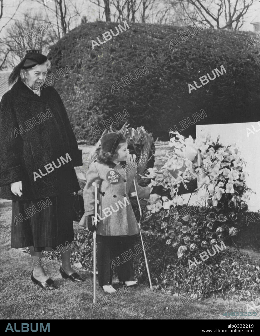 Poster Girl At FDR's Grave - Mary Kosloski, 5, of Collierville, Tenn., the 1955 March of Dimes poster Girl, looks at the grave of the late President Franklin D. Roosevelt after placing a wreath there today. With the youngster is Mr. Franklin D. Roosevelt, who accompanied the child to the grave for the ceremony marking the 73rd birthday anniversary of the former president and founder of the National Foundation for Infantile Paralysis. January 30, 1955. (Photo by AP Wirephoto).