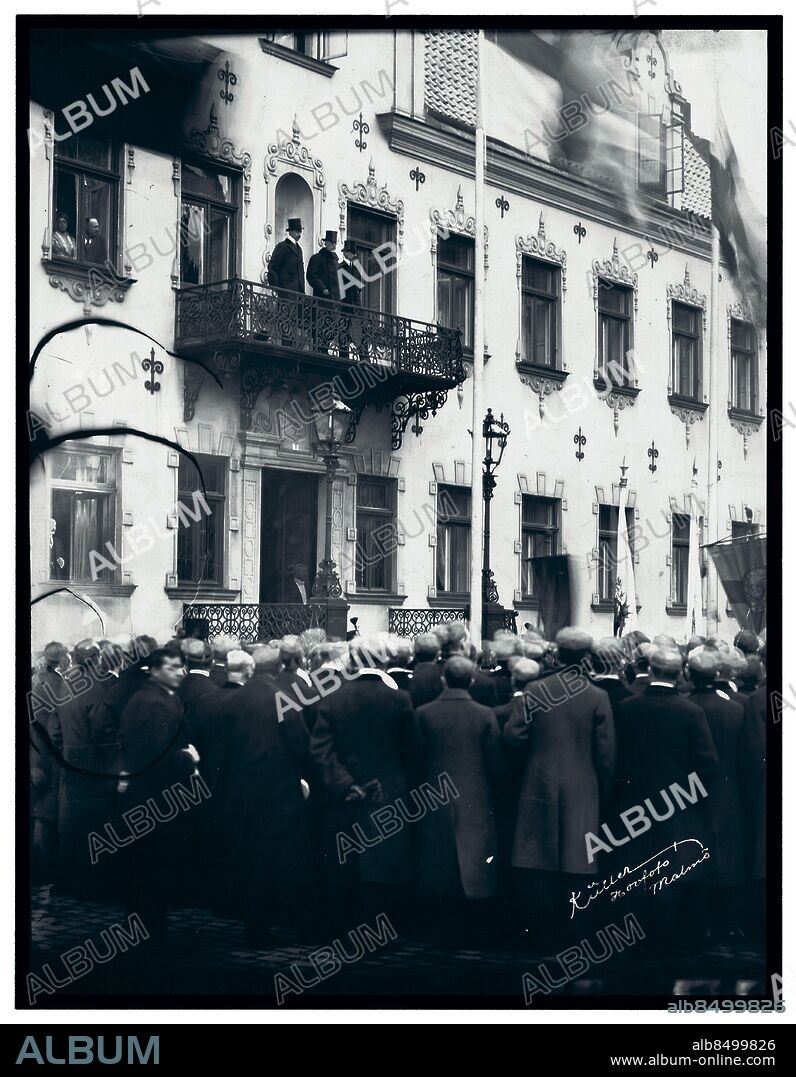 Trekungamötet i Malmö 1914 de tre kungarna på residensets balkong Lunds studentsångare höga hattar. Fr v kungarna Christian X av Danmark  Gustav V av Sverige Haakon av Norge kung kungar glasplåt. Händelser Trekungamötet i Malmö 1914. Kungliga Sverige Gustav V  Norge Haakon Christian X. (c) Ragnar Küller / Sydsvenskan / IBL.