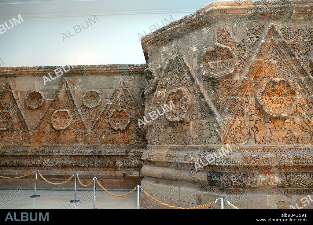 The Mshatta Facade; decorated part of the facade of the 8th century Umayyad residential palace of Qasr Mshatta, one of the Desert Castles of Jordan, which is now installed in the south wing of the Pergamon Museum in Berlin, Germany. The facade belonged to the Qasr Mshatta or Mshatta palace, which was excavated about 30 km south of the contemporary Jordanian capital of Amman. It is thought to have served as a winter residence and storage halls during the Umayyad period. The building of the palace probably dates to the era of the caliph Al-Walid II (743-744). After Al Walid was murdered, it was left incomplete and later ruined in an earthquake. Unusually for an Umayyad building, the main structures are built from burnt bricks resting on a foundation layer of finely dressed stone; the carved facade is also in stone.
