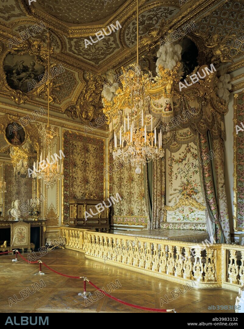 The Queen's Bedchamber, The Queen's Suite (Grand Appartement de la Reine), Chateau de Versailles, France. The Rococo-style woodwork, as well as the ceiling painting by François Boucher (1703-1770) were commissioned around 1730 by Louis XV in order to please his wife, Maria Leszczinska. Marie-Antoinette found this terribly old-fashioned, and decided to replace all the furnishings, notably commissioning silk hangings woven in patterns of lilacs and peacock feathers, garnishing the alcove and the enormous four-poster bed (restored in 1976).