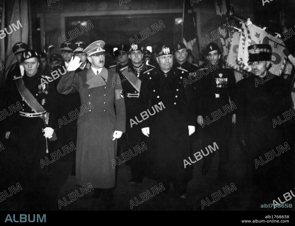 Hitler,  Mussolini and some fascist and nazi leaders in Florence. The German Chancellor Adolf Hitler accompanied by the Italian head of the government Benito Mussolini, the minister of Foreign Affairs Galeazzo Ciano and other leaders at the train station in Florence. Florence, 10th May 1938.