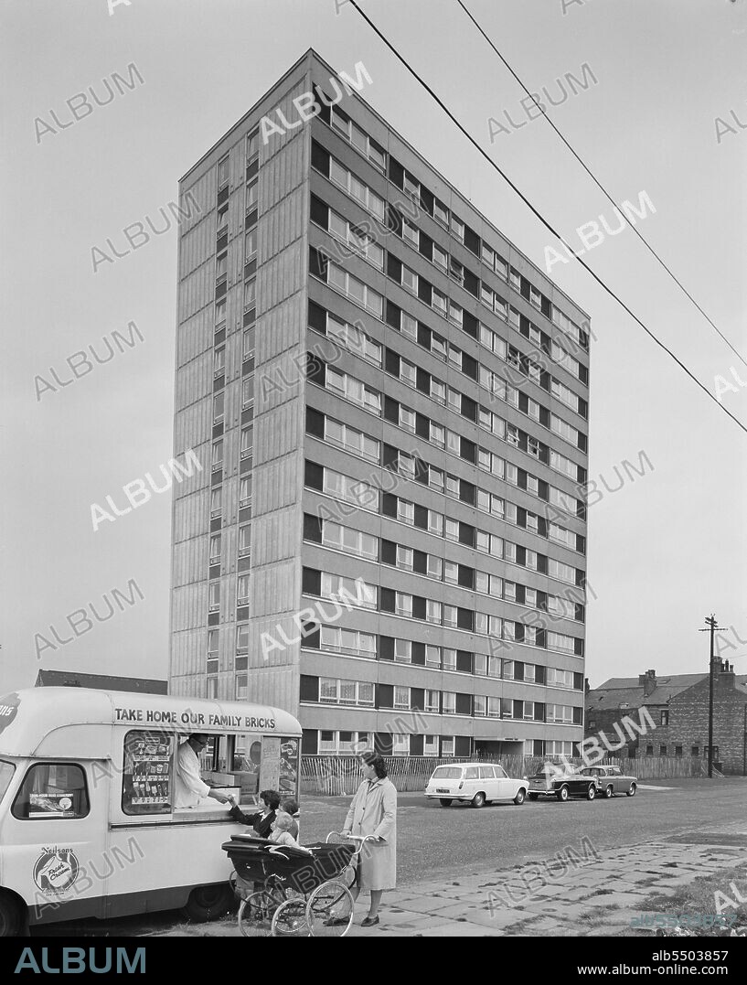 JOHN LAING PLC. Hornchurch Court, Bonsall Street, Hulme, Manchester, 12/08/1965. A recently completed multi-storey block of 'Sectra' flats in Hulme, probably Hornchurch Court, with a family in the foreground buying from an ice cream van. 'Sectra’ was a French prefabricated steel formwork design for flats which John Laing and Son Ltd acquired the British rights to in 1962. It was a method of using precision made steel formwork for the placing of structural concrete in 'tunnel' sections in room unit widths and ceiling heights. The units were bolted together in rows on special tracks, with the concrete poured to form the walls and floors in one operation. The formwork was internally heated to accelerate the hardening of the concrete in the mould and the sections were then lifted into position by a tower crane on the construction site. Hornchurch Court was the first of three multi-storey blocks that Laing built in Hulme for the City of Manchester to replace 5,000 slum houses. The company started working on the site in October 1964 and finished 18 weeks later with the opening taking place on 10th May 1965. The other two blocks were due for completion at seven-week intervals.