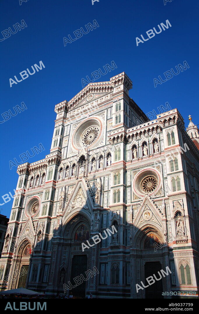 Detail from the façade from the Basilica di Santa Maria del Fiore, more commonly called the 'Duomo'. Florence, Italy. Started in 1296 based on Arnolfo di Cambio's design, but was not complete until 1436 when Filippo Brunelleschi engineered the dome. One of Italy's largest churches. The current façade was designed by Emilio De Fabris in 1871 and was completed in 1887. The original, incomplete façade was dismantled in 1588. The entire façade is dedicated to Christ's mother.
