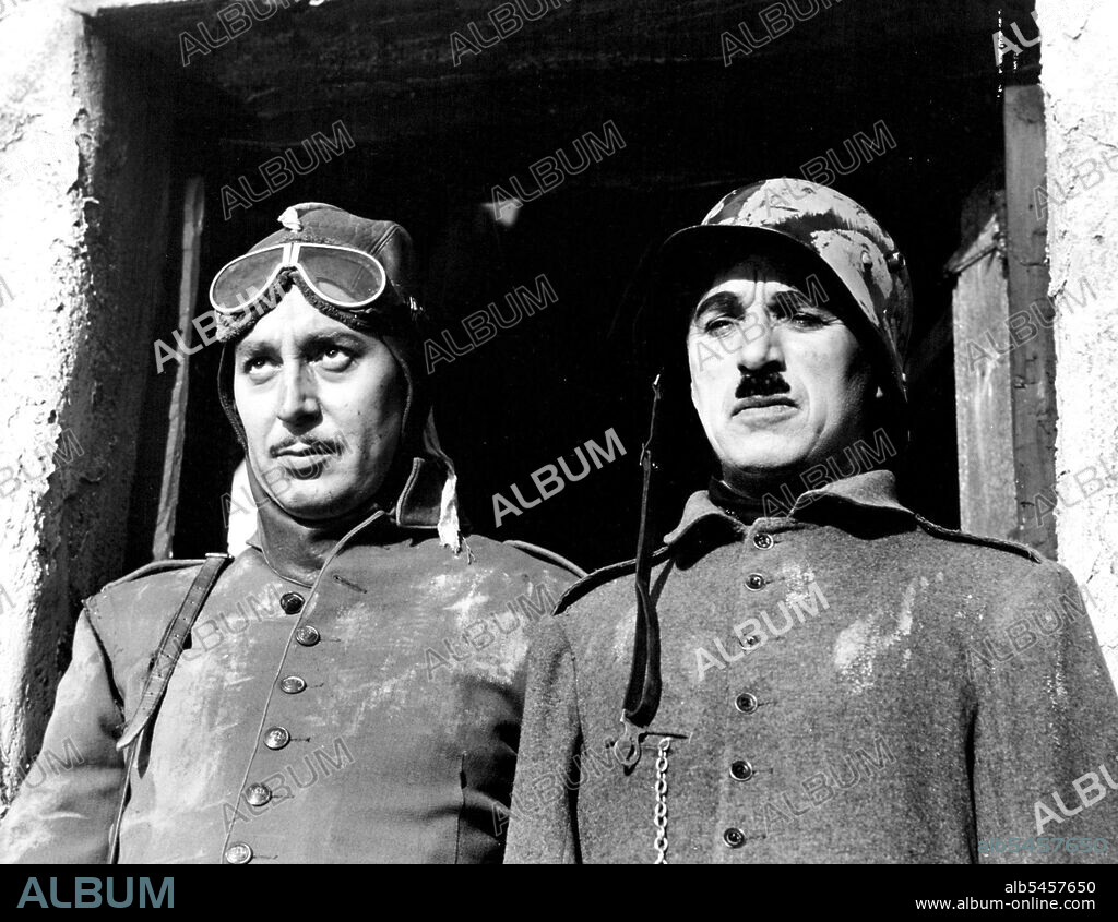 Charlie Goes Totalitarian - Charlie Chaplin, diminutive comedian who proved actions speak louder than words with his side-splitting pantomine, is soon to release his new picture, "The Great Dictator", is which he takes a resounding slap at totalitarian regimes. When the mirror is held before the frowning countenances of the conquerors across the sea, at the Chaplin angle, they collapse into ludicrous figures that make the beholder shake - with laughter. Here is the "great Dictator" (right) standing beside a fellow soldier (Regibald Gardiner) in one of the early scenes of the picture dealing with their World War days. Even back in those "Great Dictator" must have been getting a whiff of the politics under his forthcoming regime. August 16, 1940. (Photo by Acme).