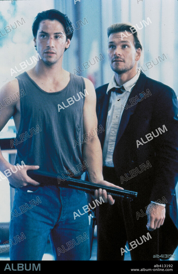 KEANU REEVES and PATRICK SWAYZE in POINT BREAK, 1991, directed by KATHERINE BIGELOW. Copyright 20TH CENTURY FOX.