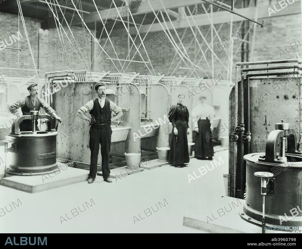 Boundary Street Area Laundry, Bethnal Green, London, 1897. Staff are shown in the laundry surrounded by large sinks and presses.