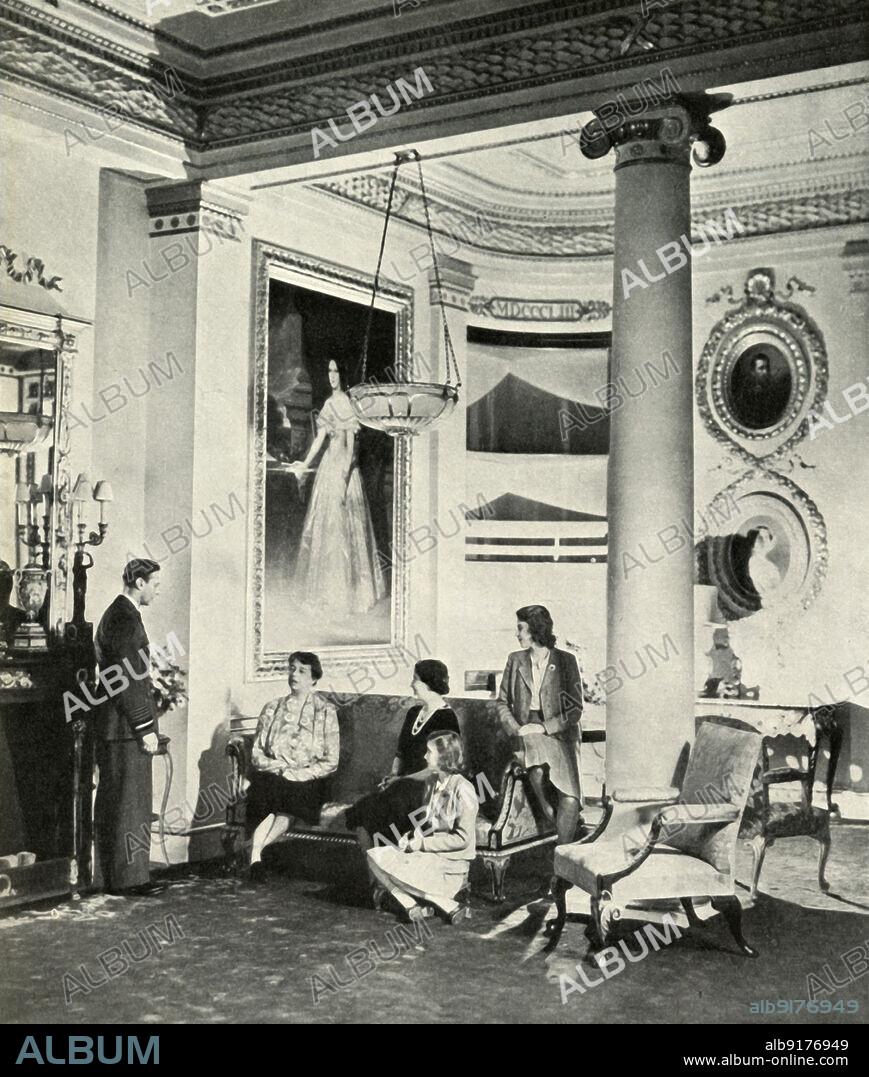 'Mrs. Roosevelt at the Palace', October 1942, (1947). King George VI and Queen Elizabeth with daughters Princess Elizabeth (future Queen Elizabeth II) and Princess Margaret Rose, with US First Lady Eleanor Roosevelt in the Bow Room at Buckingham Palace. From "Princess Elizabeth: The Illustrated Story of Twenty-one Years in the Life of the Heir Presumptive", by Dermot Morrah. [Odhams Press Limited, London, 1947].