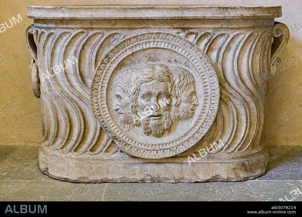 Pagno di Lapo Portigiani (workshop of Michelezzo), central nucleus of altar with the Trinity depicted in the centre, (1449-1452), marble, from the temple of the church of the Santissima Annunziata and inserted on the front of a funeral urn of Roman times.