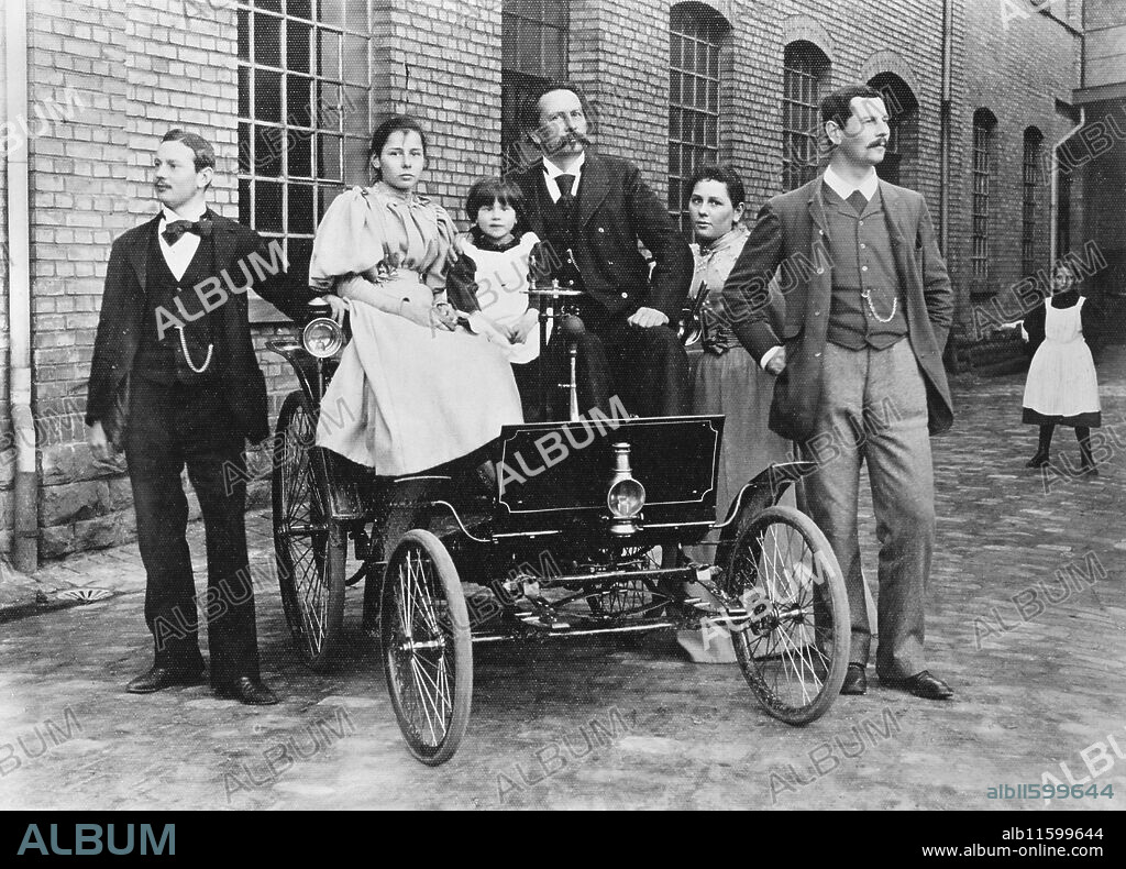 ANONYMOUS. Carl Benz with his family at his Benz Velo in the Mannheim factory yard.