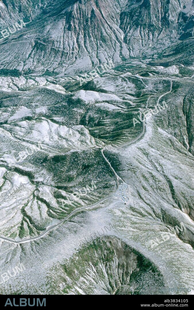 Aerial view of Mount St. Helens National Volcanic Monument, showing Visitor Center and road through desolated area. 1983.